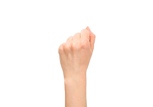 A woman's hand shows a fist isolated on white background. Back side. Close-up.