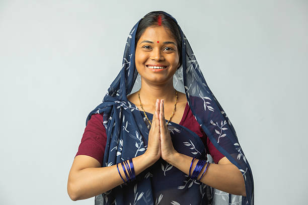 istock Woman in prayer pose standing on white background 2212785522