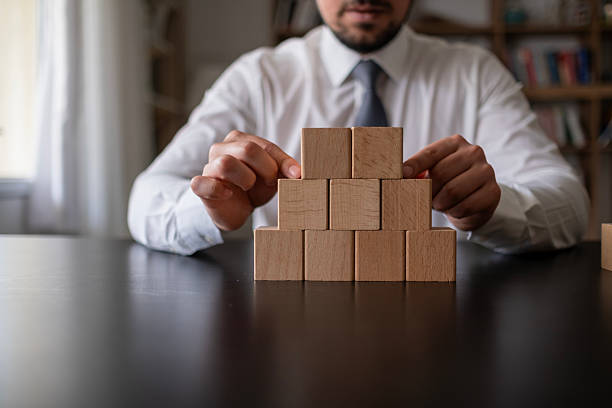 istock Businessman hand putting blank wooden cube block stack on dark background with copy space for input text, icon, trend, creative idea, finance, leadership, strategy, business, online marketing concept. 2212786335