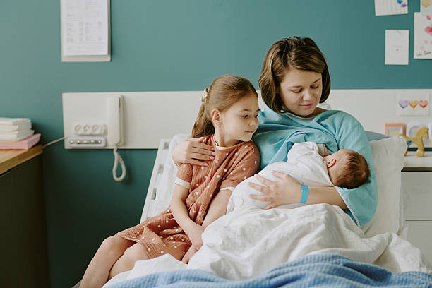 istock Watching Over New Sibling in Hospital Room 2212787078