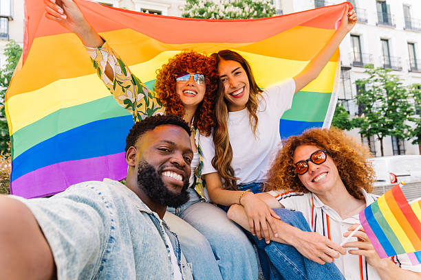 istock Multiethnic group smiling, posing with rainbow flag during pride event, capturing pride parade moment and celebrating unity 2212788824