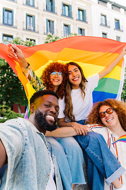 istock Multi-ethnic friends smiling, taking selfie with rainbow flag, celebrating lgbtq+ pride, embodying diversity and inclusivity with joyful connection 2212789034