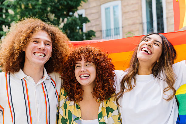istock Pride parade participants waving multicolored flag, radiating happiness while supporting lgbtq equality, embracing community spirit with bright smiles and colorful attire 2212789037