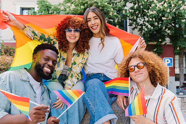 istock Diverse group of young activists waving colorful rainbow flags during pride parade, expressing unity, inclusivity, and solidarity for lgbtq+ rights and visibility 2212789328