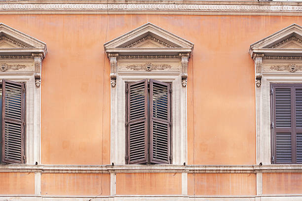 Rome, Italy - September 15 2022: Italian Orange Building with Green Window Shutters in Rome, Italy Close Up