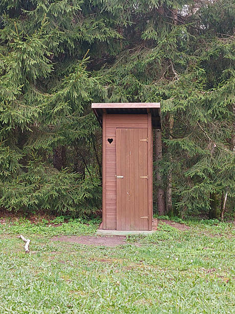 istock Rustic Wooden Outhouse in Forest Clearing, Latvia 2212791370