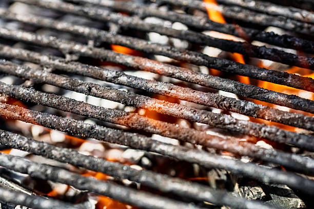 istock Hot empty barbecue BBQ grill with flaming fire and ember charcoal 2212791764