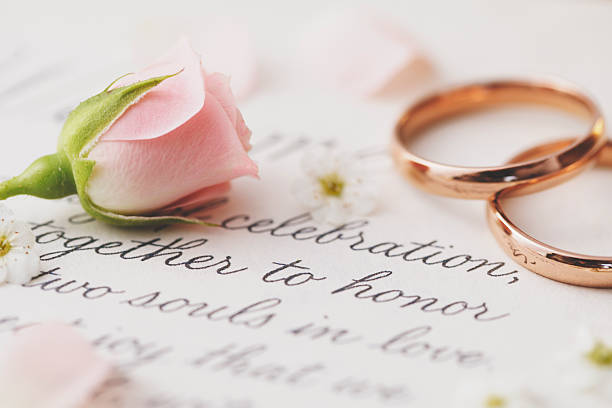 istock Wedding invitation card with gold rings and rose bud 2212792990