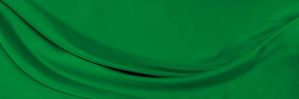 istock Black green satin dark fabric texture luxurious shiny that is abstract silk cloth background with patterns soft waves blur beautiful. 2212792992