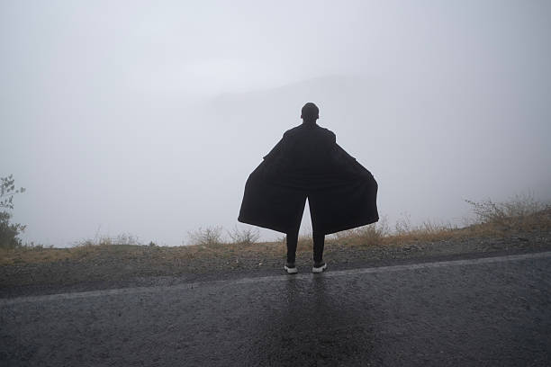 Lone man standing through the white fog