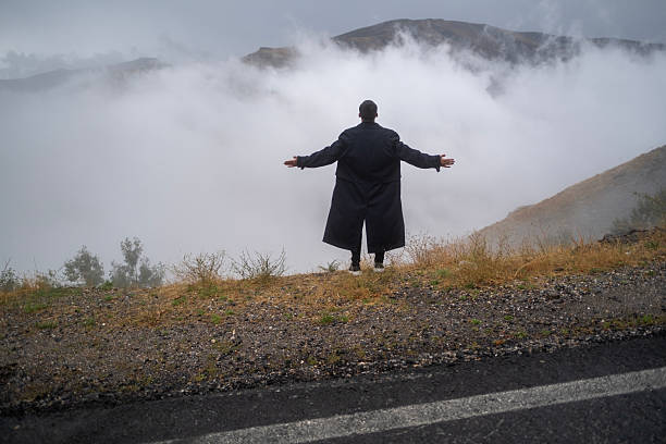 Lone man standing through the white fog