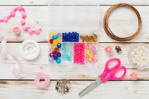 istock Tools and beads for making handmade jewelry on wooden background, top view 2212795786