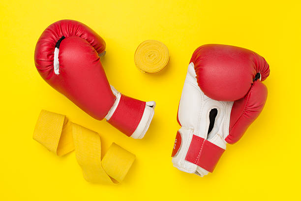 istock Red boxing gloves on color background, top view. 2212795946