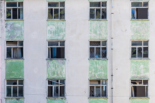 istock Broken windows in an abandoned apartment building. 2212796212