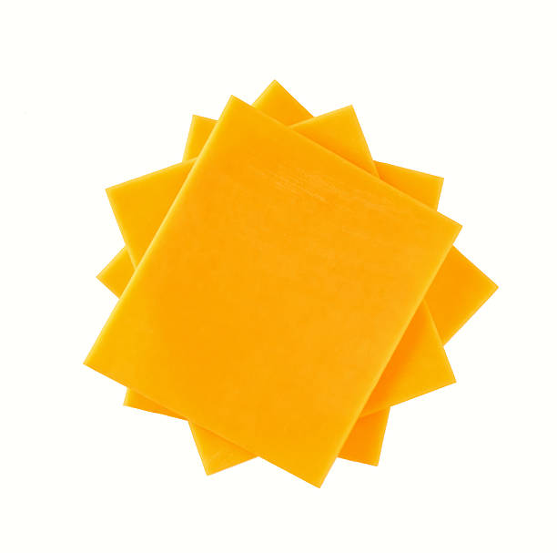 istock Stack of cheddar cheese slices, sliced natural cheese cheddar isolated on a white background, top view. 2212796373