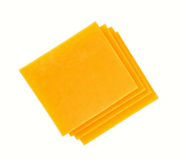 istock Stack of cheddar cheese slices, sliced natural cheese cheddar isolated on a white background, top view. 2212797021
