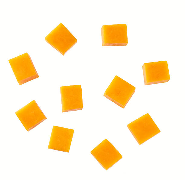 istock Cubes of cheddar cheese isolated on a white background, top view. 2212797038