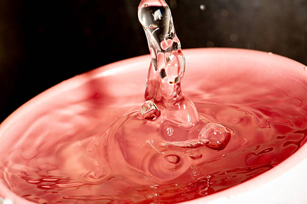 Water drop, a beautiful drop of water falling into a mug seen from a macro lens, selective focus.
