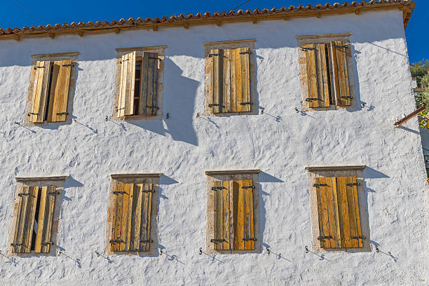 Dhermi, Hermare, Vlore, Albania. Wooden shuttered windows on a building in Dhermi, Albania.