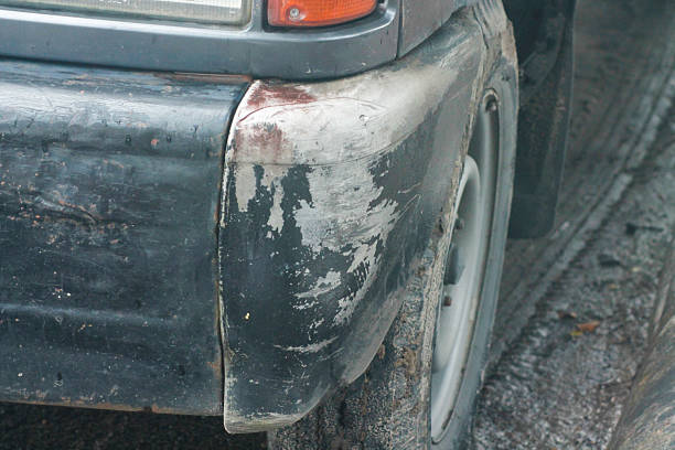 istock Black bumper car scratched with deep damage to the paint. 2212800652