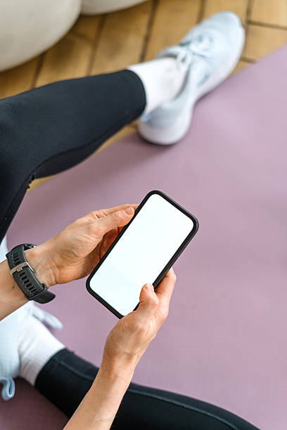 istock Fitness tracker app in use during home workout session by a young woman 2212800814