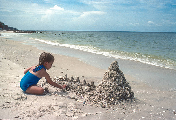 An Asian little girl stood on the shore, looking at the sea