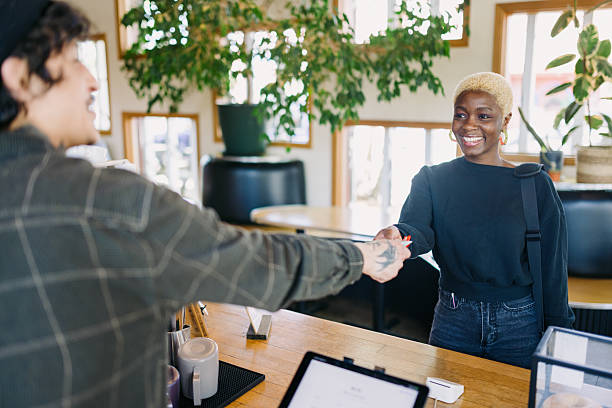 istock Woman Paying For Order At Coffee Shop 2212802339