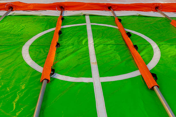 Colorful inflatable soccer field inviting playful matches under a bright sky for kids this sunny afternoon in the park