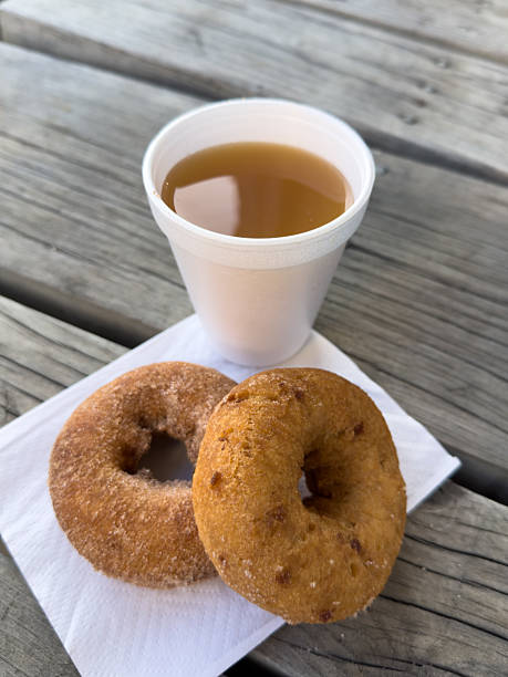 istock Cup of apple cider and cinnamon sugar donuts 2212806135