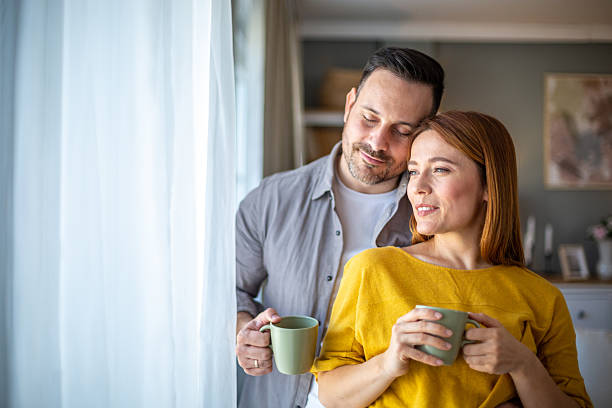 istock Loving couple sharing a quiet moment with coffee by the window 2212807370