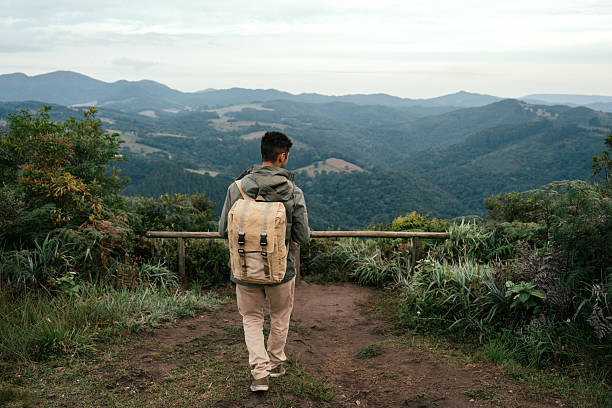 istock Young adventurous man walking on mountain trail 2212808413