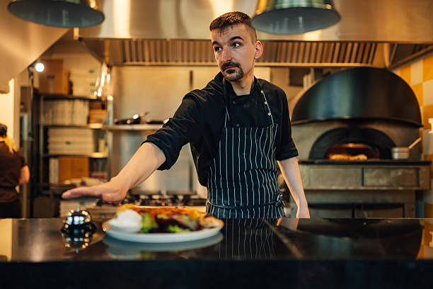 istock Chef ringing service bell for prepared dish in restaurant kitchen 2212809304