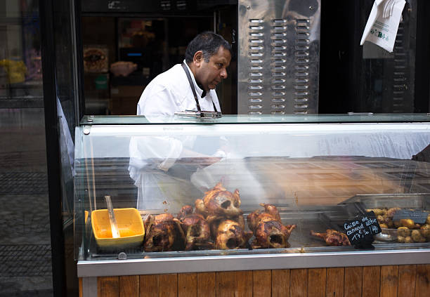 Paris, France: A chef/vendor roasting chickens and ducks on Rue Cler, a pedestrian street in the 7th arrondissement.