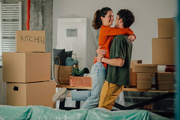 istock Happy couple embracing while moving into new apartment 2212811455