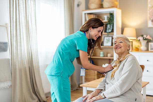 istock Smiling Nurse Caring for Elderly Patient in Comfortable Home Setting 2212812220