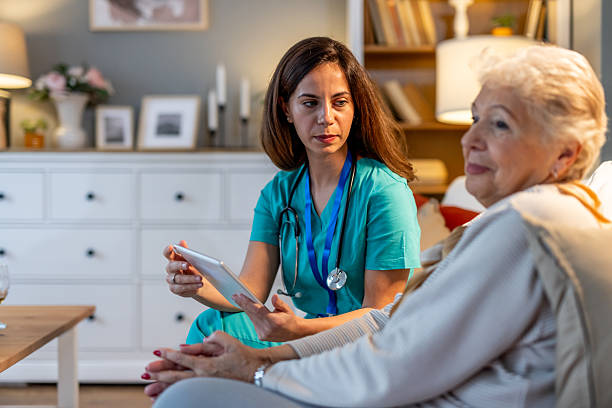 istock Home Nursing Care Visit, Nurse Assisting Elderly Patient with Compassion 2212812224
