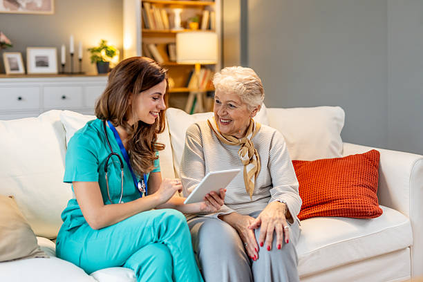 istock Nurse Assisting an Elderly Woman in a Cozy Home Setting 2212812233