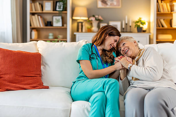istock Caring Nurse Helping Elderly Woman in a Comfortable Home Environment 2212812253