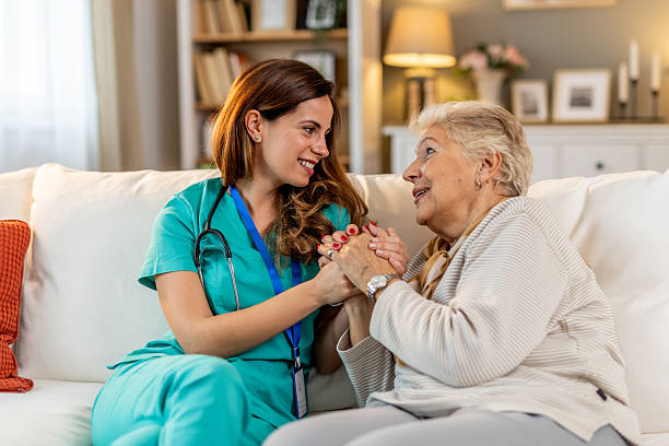 istock Friendly Nurse Assisting Elderly Woman With Care and Support on Sofa 2212812254