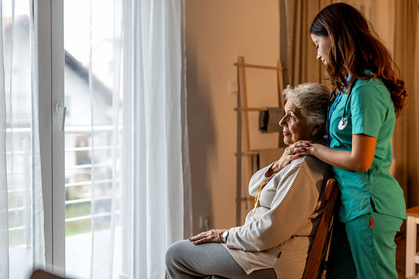 istock Nurse Providing Care for Elderly Woman in Bright Home Setting 2212812290