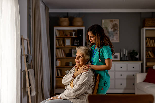 istock Caring Nurse Assisting an Elderly Woman in a Cozy Home Setting 2212812297
