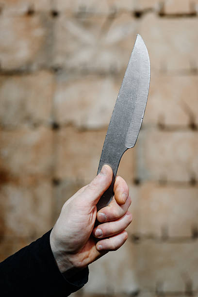 istock metal knife in wooden target 2212812344
