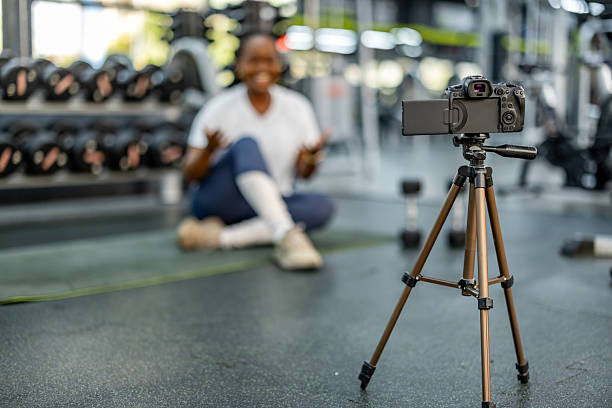 istock Fitness Influencer Filming a Workout Tutorial in a Modern Gym Environment 2212814722