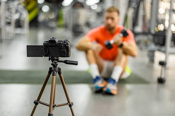 Fitness Vlogger Recording Workout Routine at a Gym
