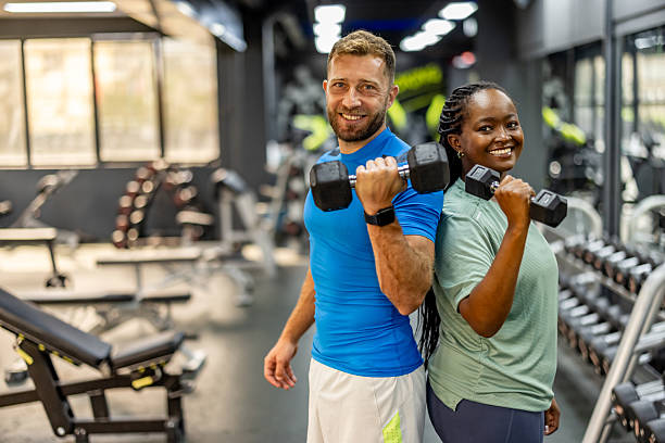 istock Diverse Friends Exercising Together With Dumbbells in a Modern Gym Setting 2212814739