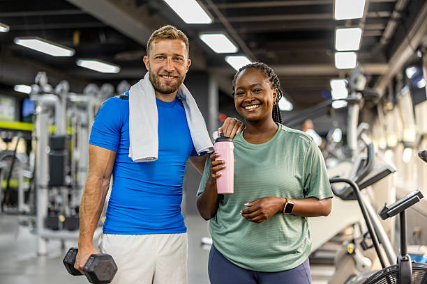 istock Two Friends Smiling After a Workout Session at a Modern Gym Environment 2212814741