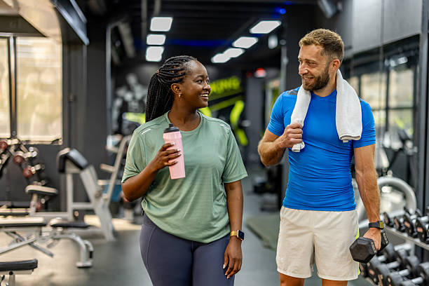 istock Two Friends Socializing During a Workout in a Modern Gym Environment 2212814745