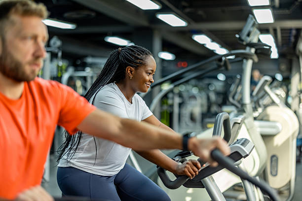 istock Happy People Exercising on Cardio Machines in Modern Gym Setting 2212814784