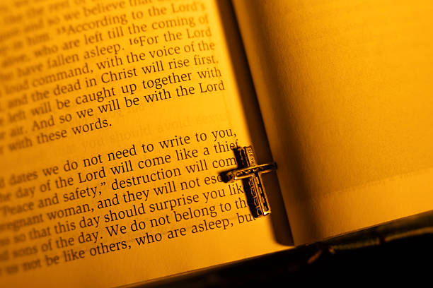 Golden wedding ring on open holy bible book. Close-up. Christian marriage, commitment, love relationship, togetherness, and blessing from God Jesus Christ, biblical concept.
