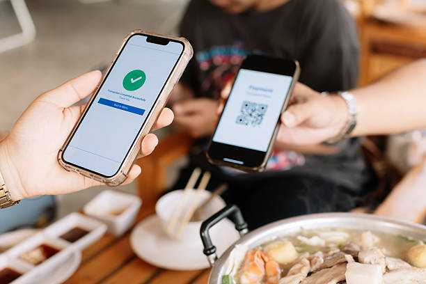 istock Selective focus to QR code tag with blurry smartphone display the payment page has been completed. Scan QR code payment. QR code tag  payment. 2212818776